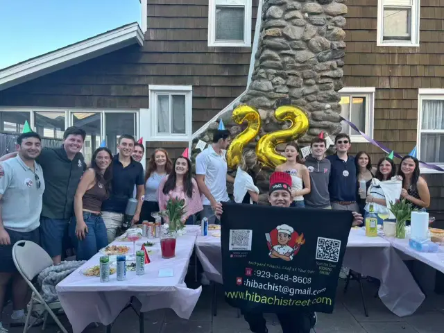 Friends celebrating a 22nd birthday at a backyard hibachi party