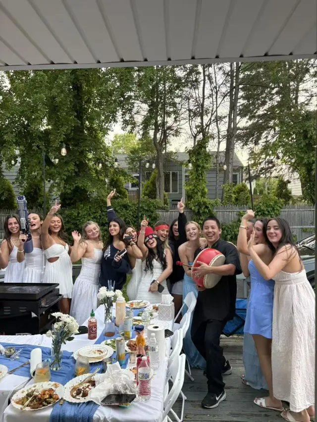 Bachelorette party dancing under a covered patio during an at-home hibachi dinner