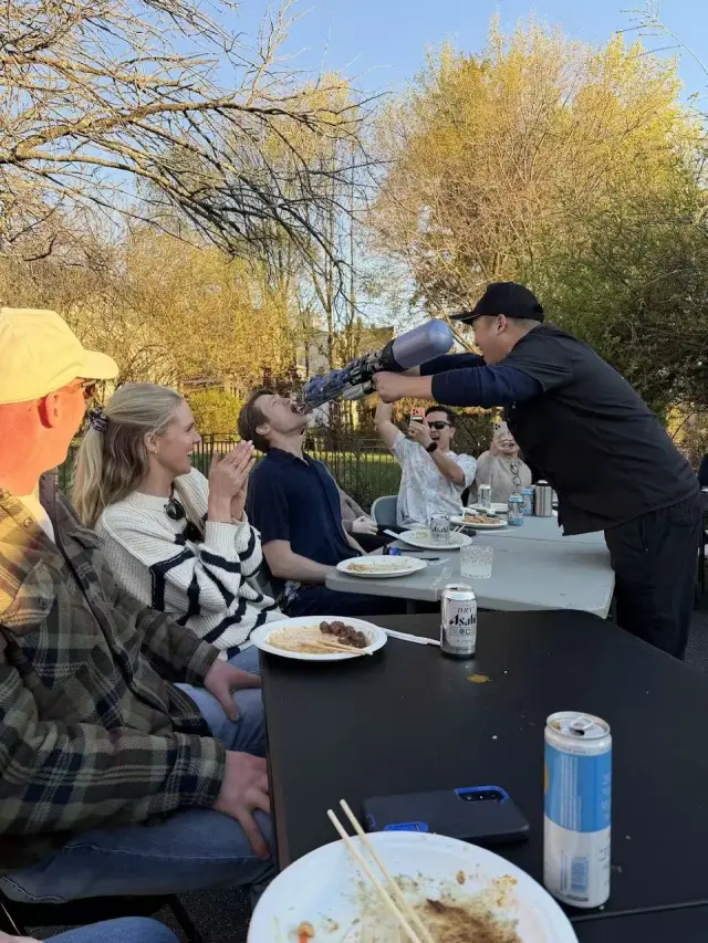 Hibachi chef tossing food for a guest to catch in the backyard