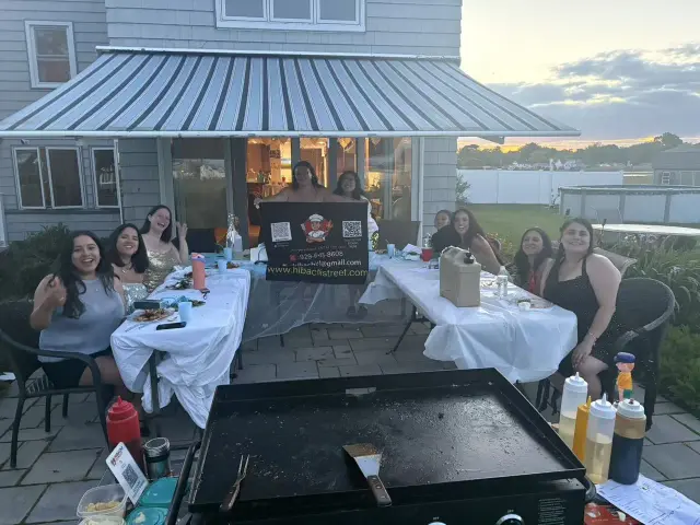 Covered patio hibachi dinner with the grill ready beside the table