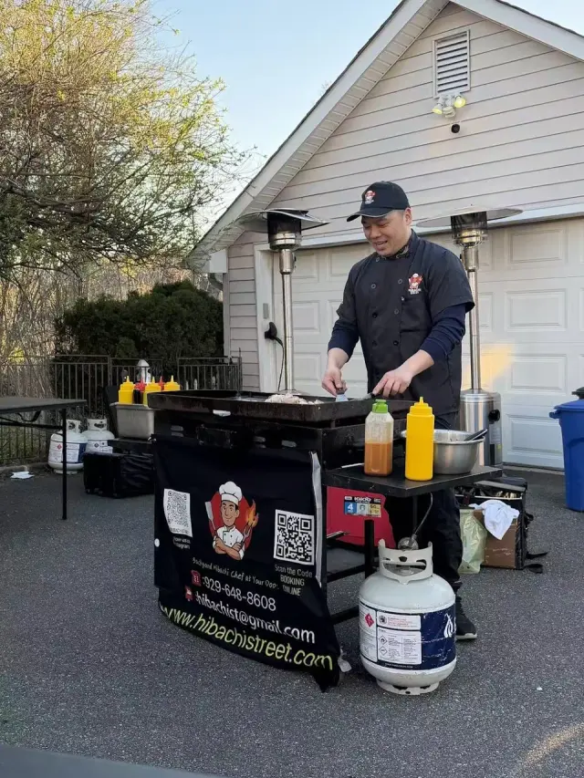 Private hibachi chef cooking on a flat-top grill in a home driveway